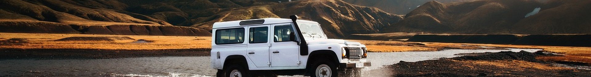 Rental vehicle driving on an open road symbolizing travel and customer questions