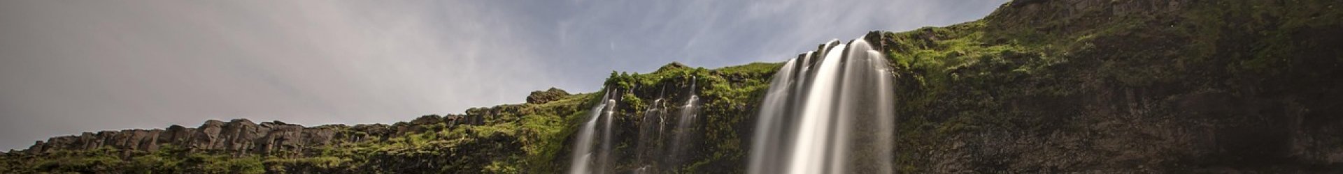 Rental car on an open road representing travel across various Iceland locations